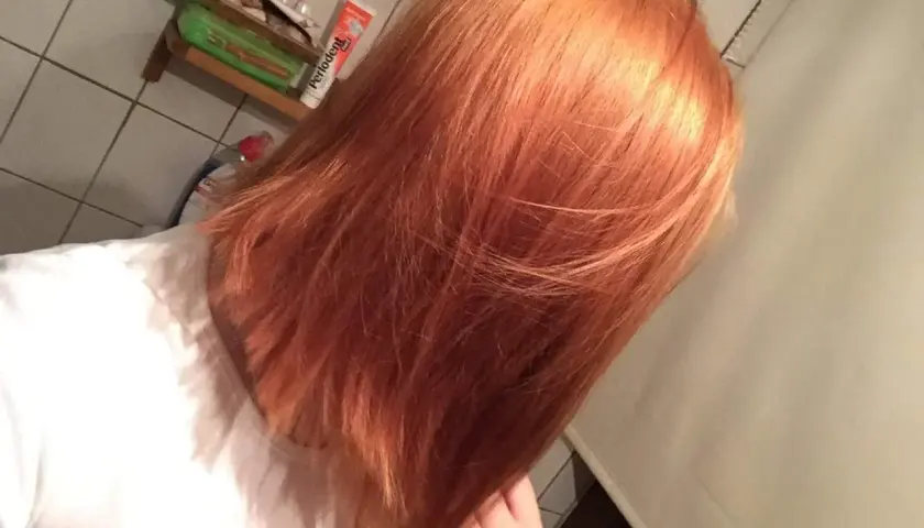 Orange Haare, bereit, nochmal blondiert zu werden. Ein Blick in den Spiegel vor dem nächsten Schritt.
